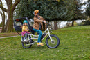 Man and child riding an ebike with rain cover